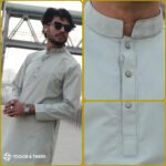 Man wearing a jacquard Pakistani Panjabi with textured fabric, styled collar, and buttoned placket, standing in a studio setting.