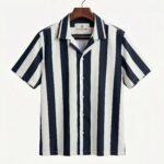 Shop the Navy and White Vertical Stripe Cuban Collar Shirt by Togor & Tweed. A versatile, premium men's short-sleeve button-up perfect for smart-casual and vacation looks. Upgrade your style today